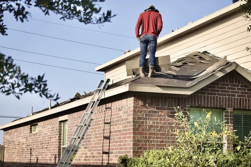 Professional roofer working on a residential roof in Van Ormer